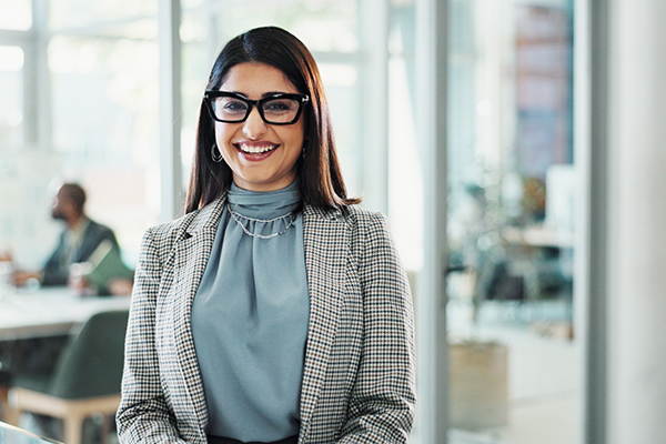 A woman in business attire smiling