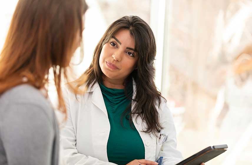 Doctor and patient having a conversation in the examination room.